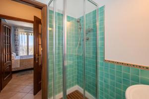 a bathroom with green tiled walls and a shower at A Casa di Beppe a Monforte dAlba in Monforte dʼAlba +15 photos