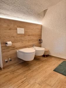 a bathroom with a white toilet and a sink at La Ca' nel Borgo in Tenno +15 photos
