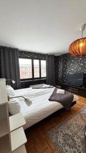 a bedroom with a large bed and a flat screen tv at Fjordhotellet in Lysekil