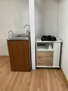 a bathroom with a sink and a counter with a mirror at Central Apartment in Cochrane