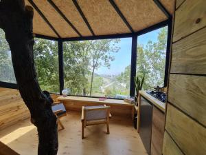 a room with a tree in the middle of a house at MONKEY MANSION - Luxury Treehouse - Private Escape with outdoor hot Tub in Abū Mīzān