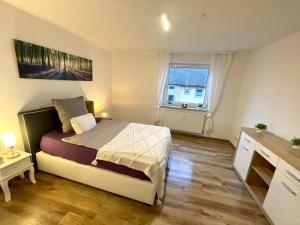 a small bedroom with a bed and a window at Allgäu Space in Marktoberdorf