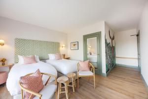 a bedroom with two beds and a table and chairs at Barnahown B&B, Mitchelstown in Mitchelstown