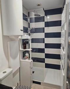 a small bathroom with a toilet and a sink at Bogota in Laon