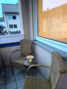 two chairs and a table with a candle on a balcony at Allgäu Space in Marktoberdorf +13 photos