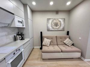a living room with a couch in a kitchen at Ривер люкс Днепр in Dnipro