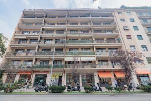 an apartment building with motorcycles parked in front of it at La casa di Gaia in Como