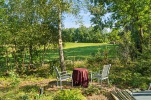 two chairs and a table in the middle of a field at KATs FRISTED in Ebeltoft