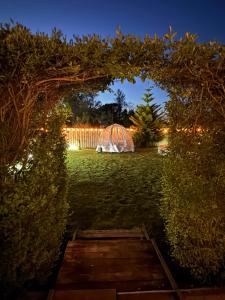 a garden at night with a tent in the background at Monte do Bidé Private Farm Peace and Nature in Setúbal
