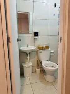 a bathroom with a toilet and a sink at Casa 1er Piso in Punta Hermosa +23 photos
