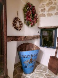 a trash can in a corner with a wreath and a bucket at Casa Fonte Vallone in Pacentro