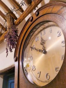 a clock is hanging on a wall at Casa Fonte Vallone in Pacentro