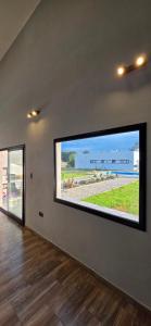 a large tv in a room with a large window at Oasis Atlántida in Santa Clara del Mar