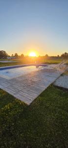 a park with the sun setting in the background at Oasis Atlántida in Santa Clara del Mar