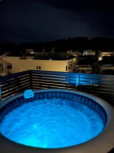 a swimming pool with blue water at night at Sandi Hvar Apartments in Hvar