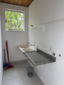 a white bathroom with a sink and a window at Casa da Glória 2 in Diamantina +21 photos