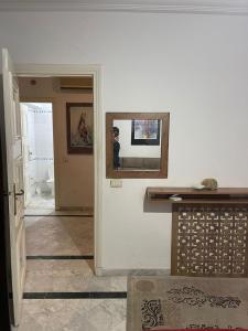 a room with a counter and a mirror on a wall at Studio in Ariana