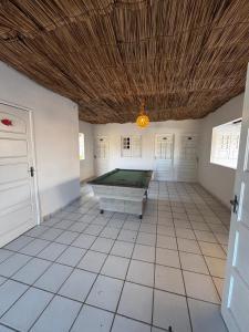a large room with a pool table on a tiled floor at Suítes Marrakesh in Porto De Galinhas
