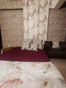 a bedroom with a large bed with a wall at StudeXO in Ghaziabad