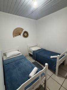 a bedroom with two beds and a hat on the wall at Suítes Marrakesh in Porto De Galinhas +41 photos