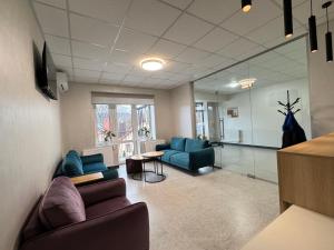 a living room with two couches and a table at Polyana Park House aparts in Polyana