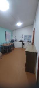 a room with a kitchen and a table in it at Cabaña lomas de chaica in Puerto Montt