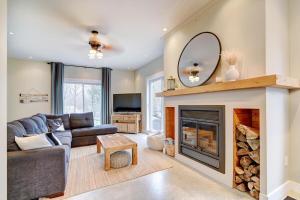 a living room with a fireplace and a mirror at Lake Joseph Retreat -Waterfront and Hot tub in Saint-Pierre-Baptiste