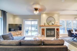 a living room with a couch and a fireplace at Lake Joseph Retreat -Waterfront and Hot tub in Saint-Pierre-Baptiste