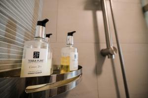 a couple of bottles sitting on a shelf in a bathroom at Casita Benito Loft A in Sangley Point Naval Station