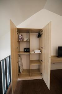 a room with a closet with wooden shelves at Casita Benito Loft A in Sangley Point Naval Station
