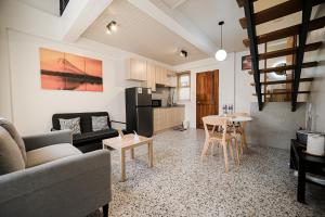 a living room with a couch and a table at Casita Benito Loft A in Sangley Point Naval Station
