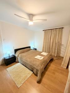 a bedroom with a bed with two towels on it at Casa da Praça de Murça in Murça