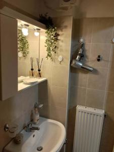 a bathroom with a sink and a mirror at ΚΝΗΜΙΣ Apartment in Agios Konstantinos +26 photos