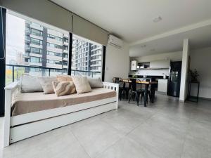 a living room with a bed and a dining room at Pionero in Neuquén