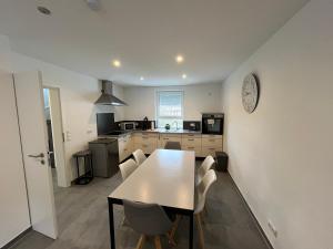 a kitchen with a table and chairs in a room at Villa Maria in Westerburg