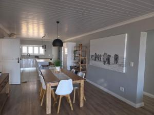 a kitchen and dining room with a table and chairs at Heuwels Haven in Mossel Bay