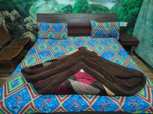 a bed with a blanket on top of it at HOTEL JOGI GUEST HOUSE welcome all families, friends, groups, couples, singles fully Airconditioner, attach washrooms, lift, wifi, gyser hot water, 24 hours room service, power backup in Amritsar +83 photos