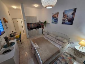 a living room with a bed and a kitchen at Igalo in Igalo