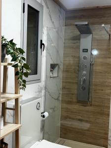 a shower with a glass door in a bathroom at La Loma de Alcalá in Arcos de la Frontera