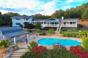 a large house with a swimming pool in front of it at 'Whispering Oaks Estate' w/ Pool & View in Murphys in Vallecito