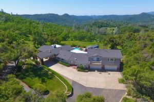 an overhead view of a large house in the woods at 'Whispering Oaks Estate' w/ Pool & View in Murphys in Vallecito