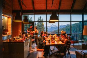 a group of people sitting at a table in a restaurant at Campfire Ranch Private Cabin, Meals Included in Bergen Park