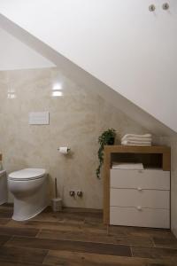 a bathroom with a white toilet and a staircase at Casa Vacanze Dolce Angelo in Sutri +36 photos