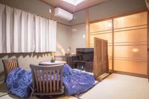a living room with a dog bed and a tv at Nijojo Taiken Inn in Kyoto
