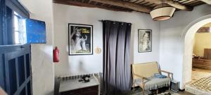 a room with a curtain and a chair and a window at Casa Doval in Cortelazor