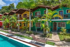 a house with a pool in front of it at Capoeira Village in Porto Seguro