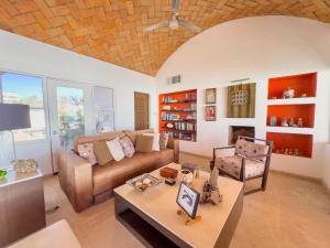 a living room with a couch and a table at Casa Ruma Beachfront Art House in Bahía Kino