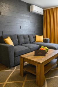 a living room with a couch and a coffee table at Libertè suites Velingrad in Velingrad +75 photos