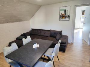 a living room with a table and a couch at DAI Apartment in Maribor