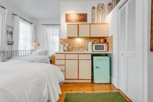 a small kitchen with two beds and a refrigerator at NIGHTCAP @ Speakeasy Inn Key West! in Key West